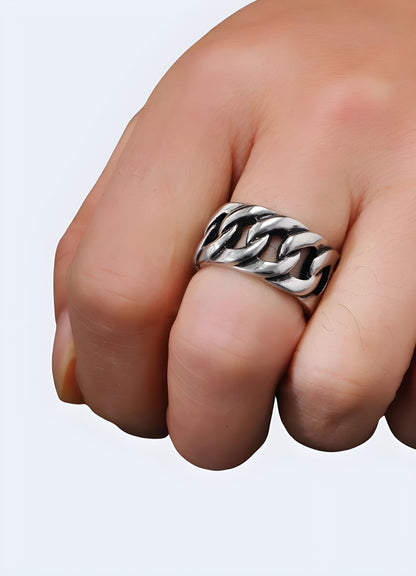 Front view of a woman wearing a chunky chain ring, highlighting the ring's bold design, available in the UK.