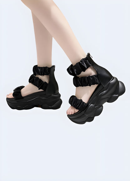 Front and side view of a woman modeling a chunky black sandal, highlighting the eye-catching design, comfortable fit, and versatile aesthetics suitable for various occasions.