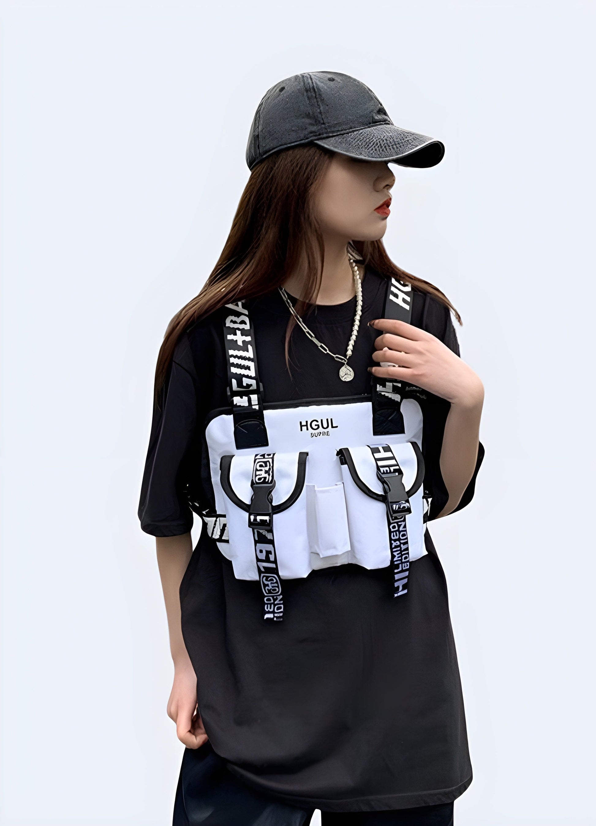 Woman wearing hip-hop chest bag, front view with model, UK. Fashion-forward and practical design.