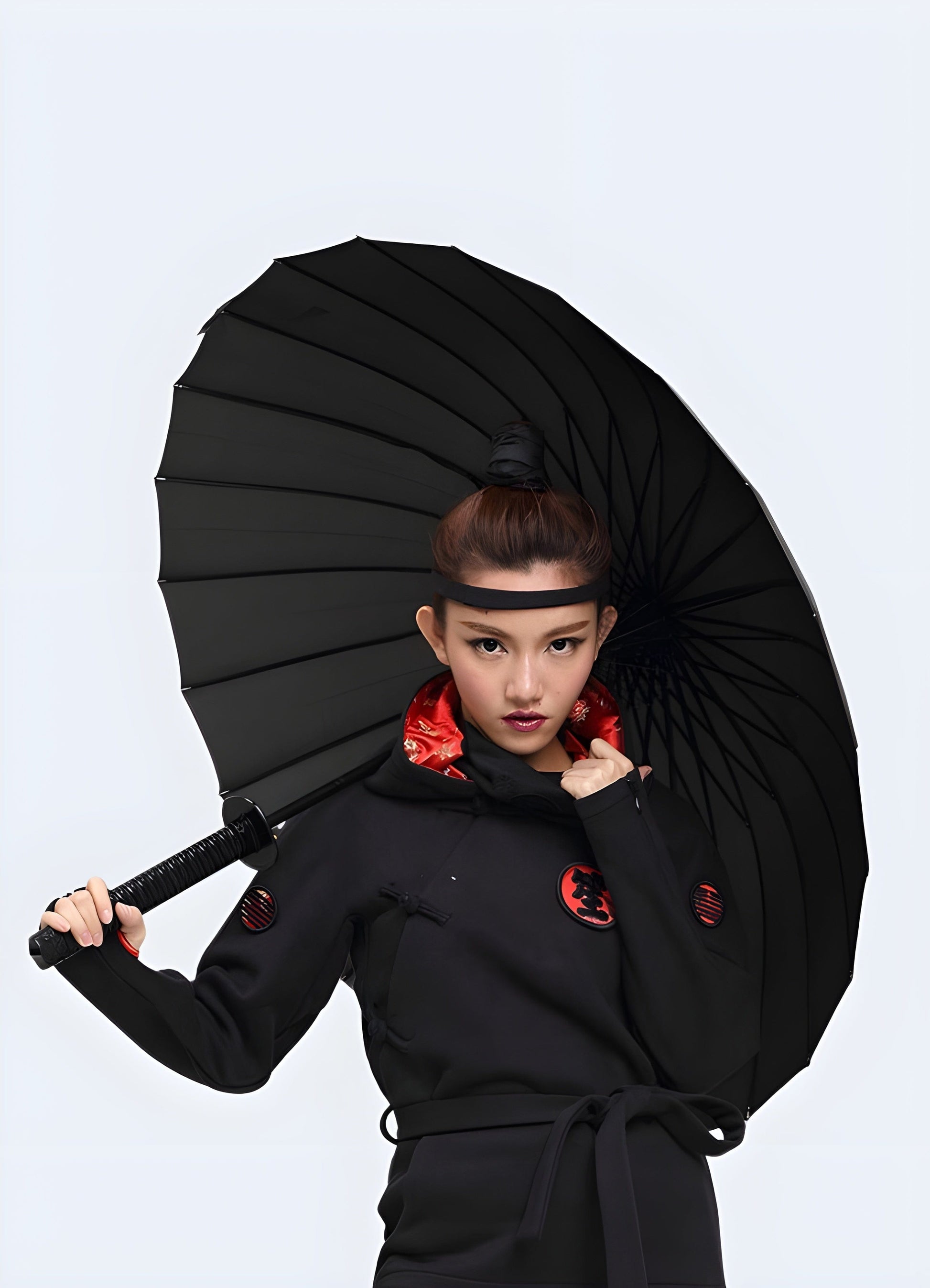 Woman holding a ninja sword umbrella with 24 ribs, shown from the front, highlighting the umbrella's sturdy construction and stylish design.