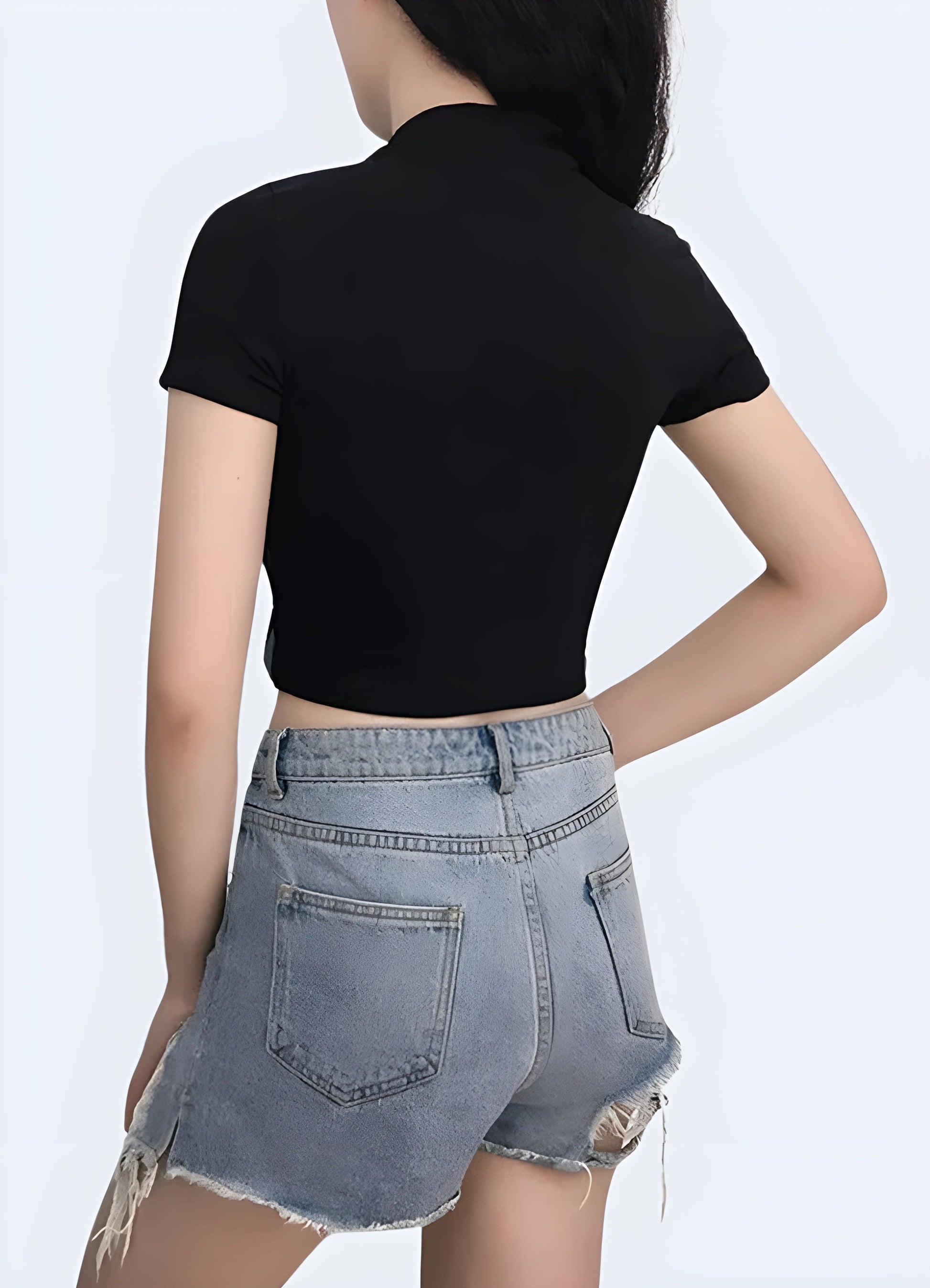 Back view of a woman wearing a techwear buckle crop top, showcasing its eye-catching buckle detail and modern silhouette for fashion-forward women in the UK.