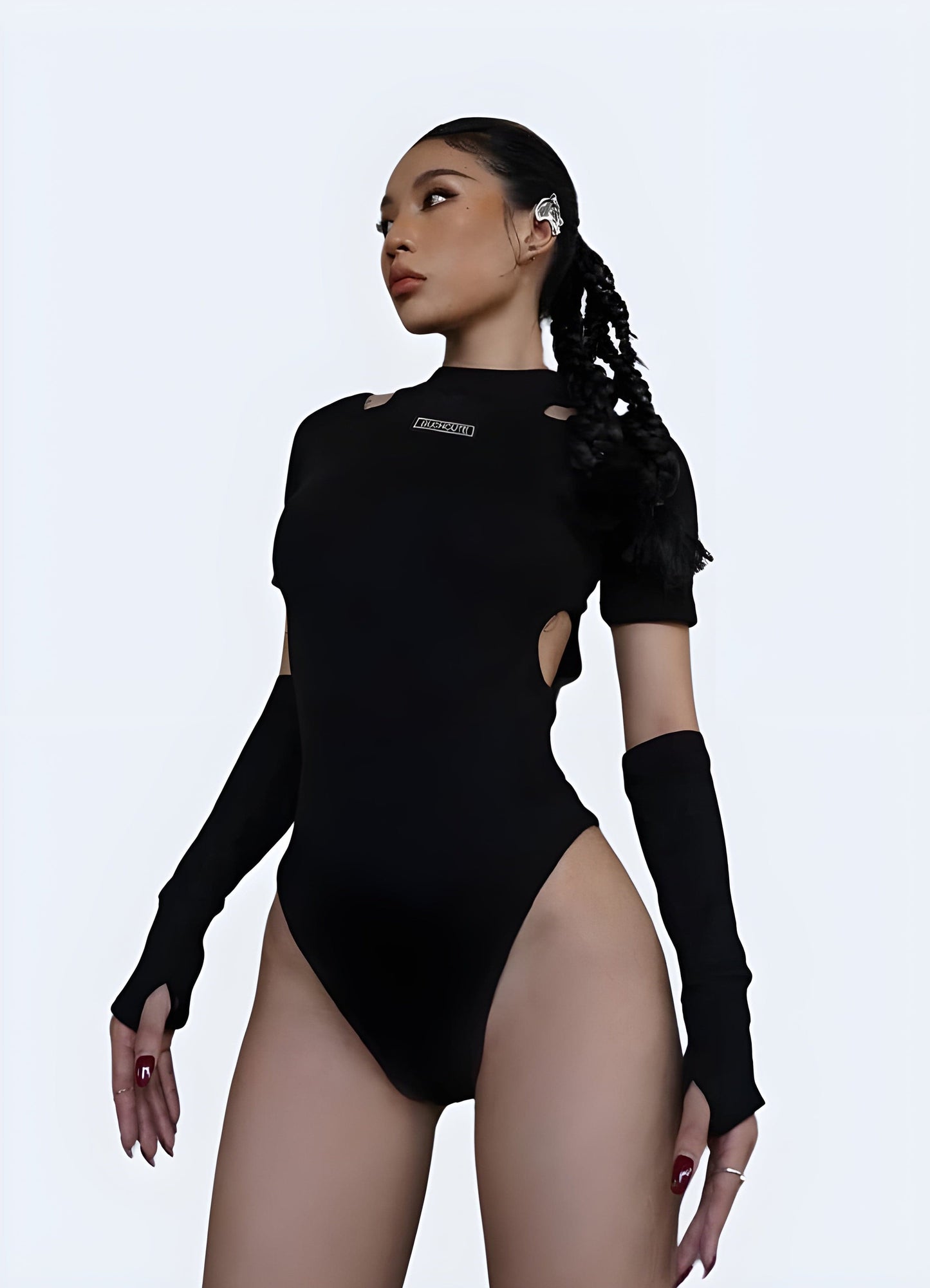 Front view of a woman wearing a contemporary techwear leotard, showcasing its sleek lines and modern aesthetic for UK urban fashion.