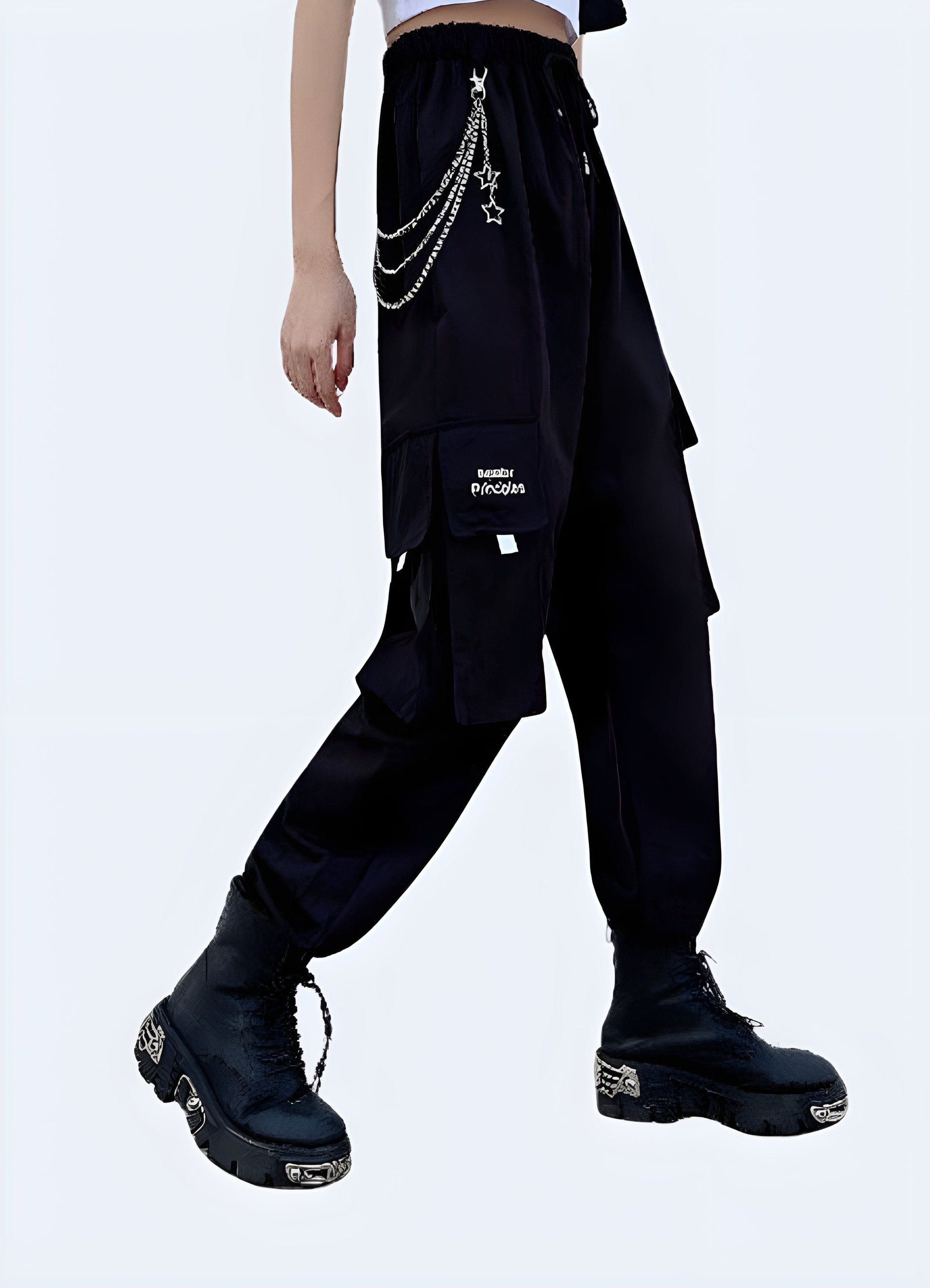 Front side view of a woman wearing stylish techwear women's pants with a chain accent, showcasing the blend of fashion and utility popular in UK street style.