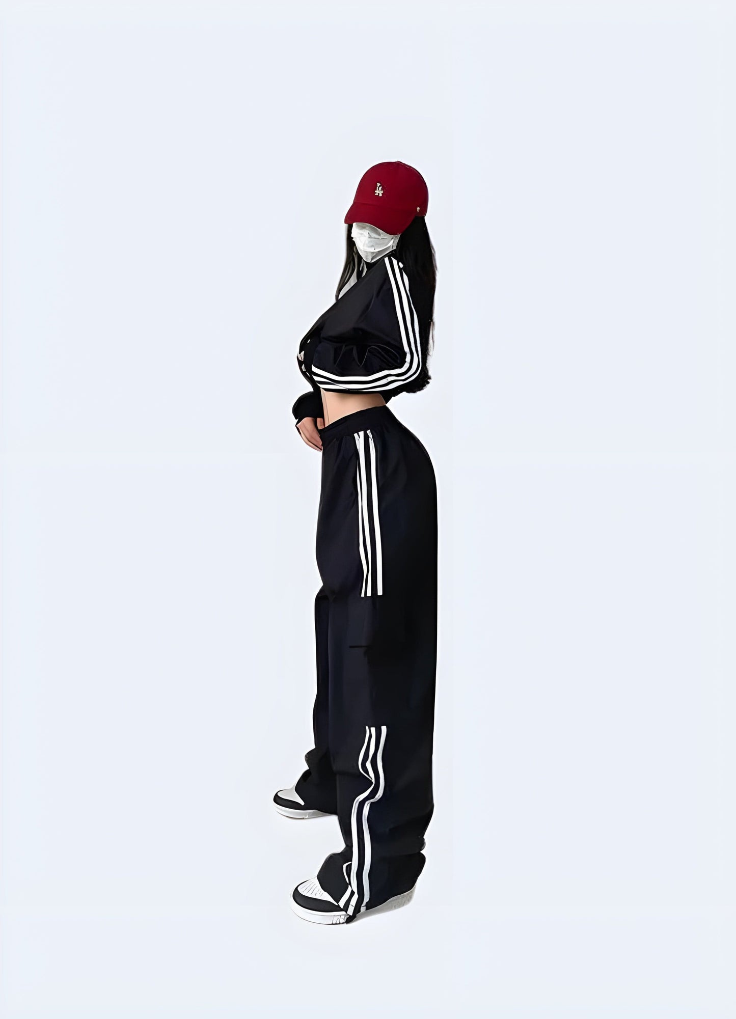 Side view of a model wearing women's techwear streetwear pants, highlighting the stylish and versatile features that appeal to the UK urban fashion scene.