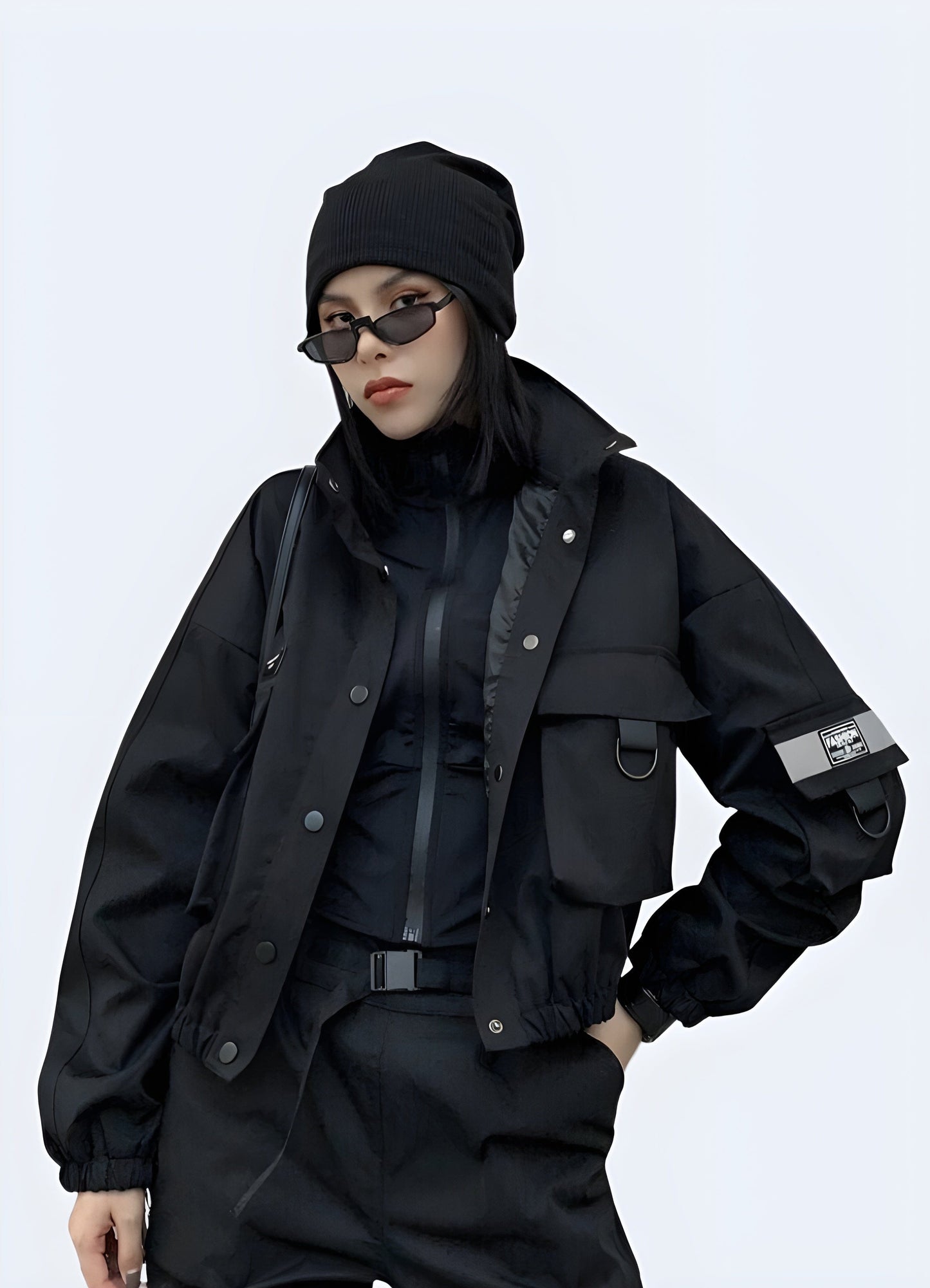 Front view of a woman wearing a black tactical bomber women, showcasing its sleek design and functional features for city life in the UK.