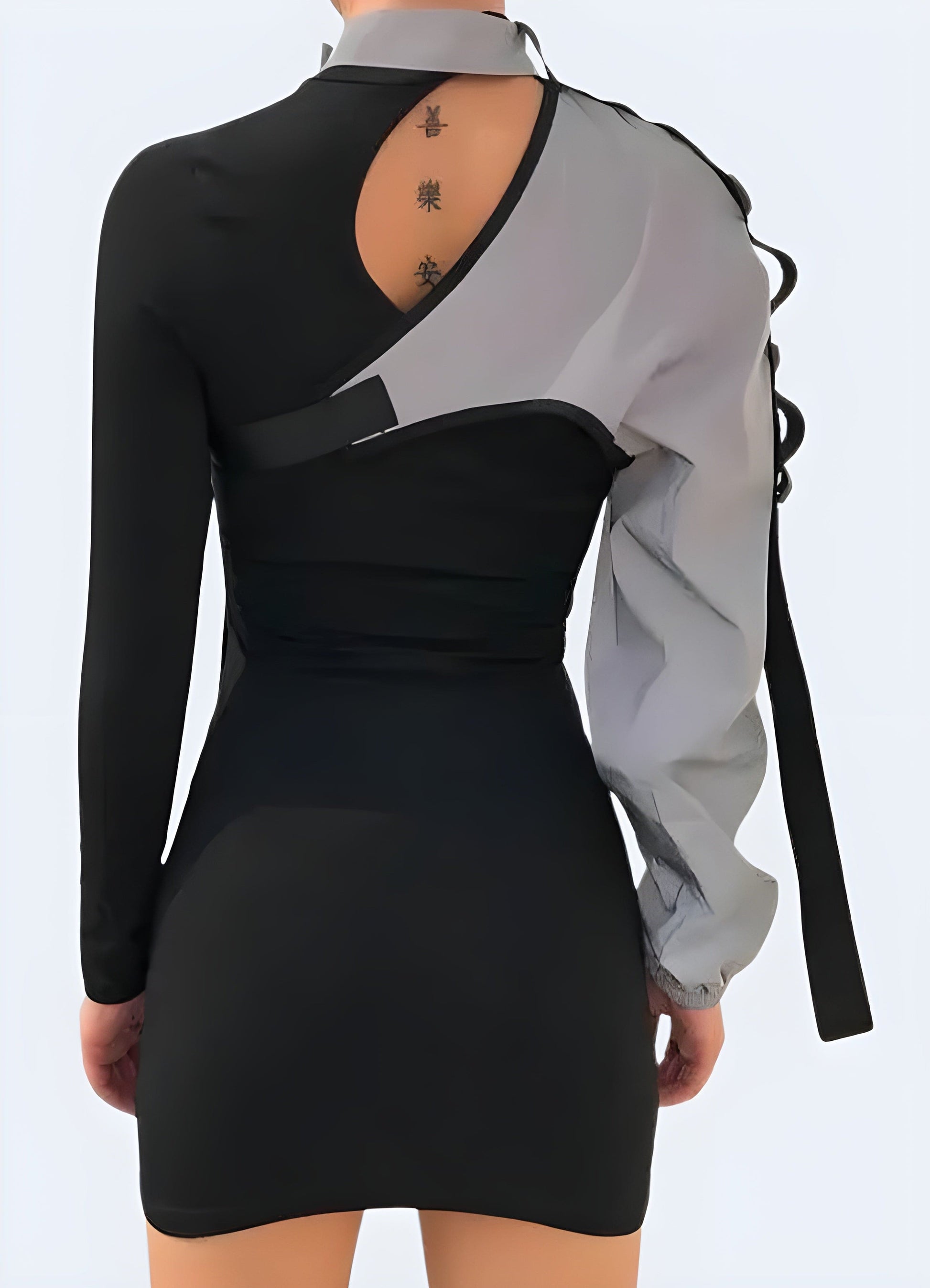 Back view of a woman wearing a one-sleeve reflective top, showcasing its unique asymmetrical design and reflective properties for safety and style in the UK.