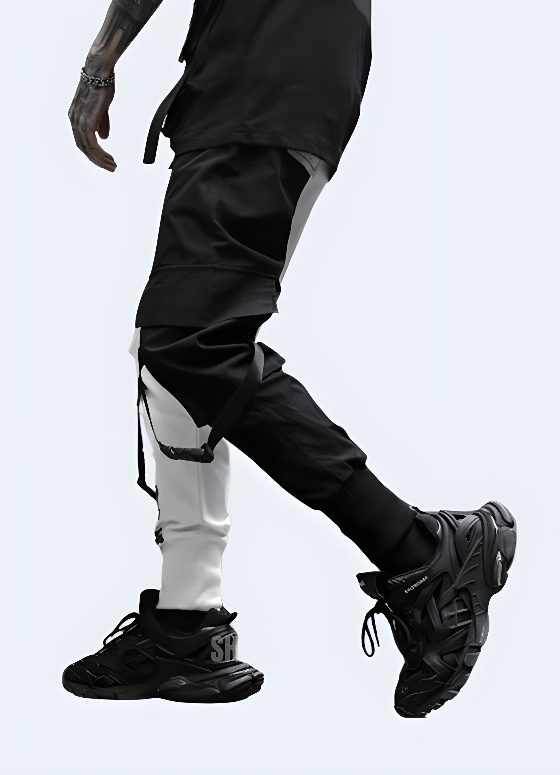 Side view of a man wearing black and white cargo pants in the UK, highlighting the contemporary style and versatile design suitable for various occasions.