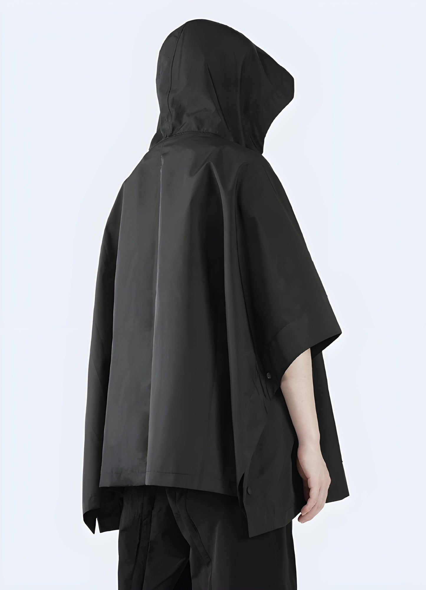 Stunning full width view of a model donning a black cape jacket, emphasizing the garment's sophistication and versatility for UK fashion enthusiasts.