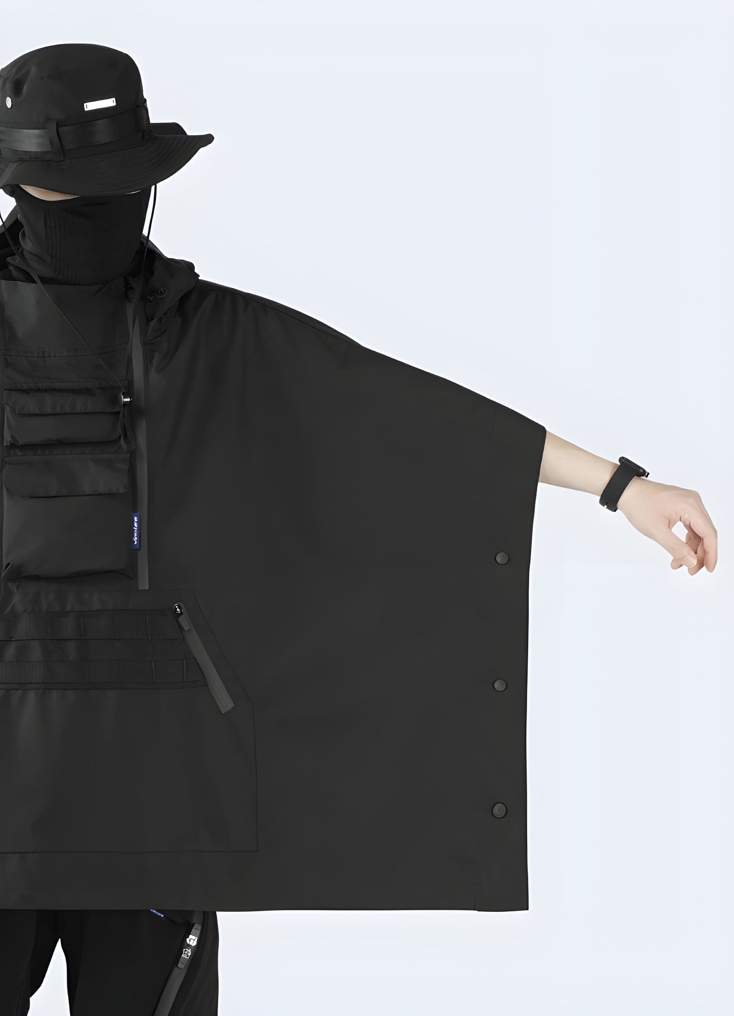 Full width view of a model wearing a black cape jacket, highlighting its impressive silhouette and luxurious fabric in the UK.