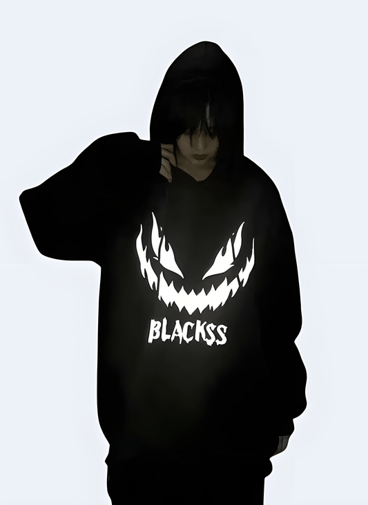 Black reflective hoodie with a sleek design, available for purchase in the UK