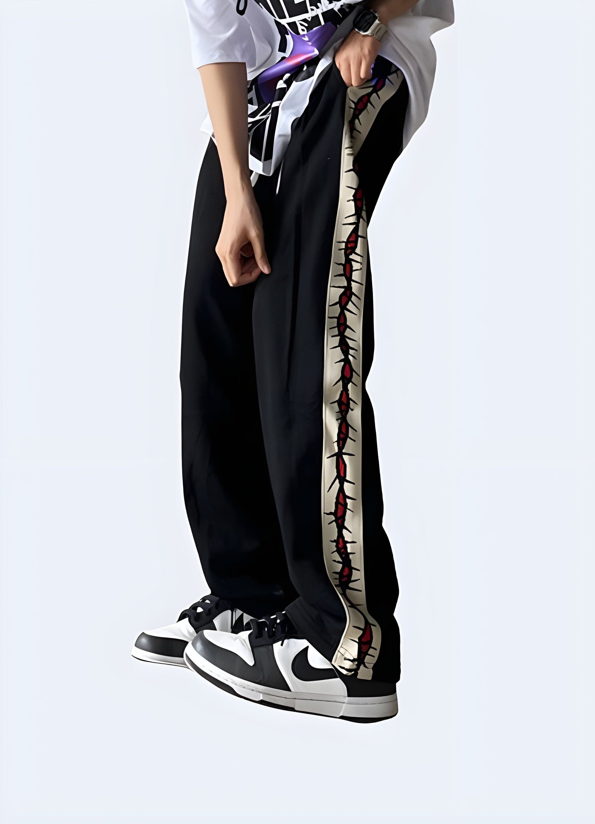 Side view of a man wearing trendy grunge sweatpants, showcasing the garment's loose silhouette and grungy details, perfect for fashion-forward individuals in the UK embracing the grunge aesthetic.