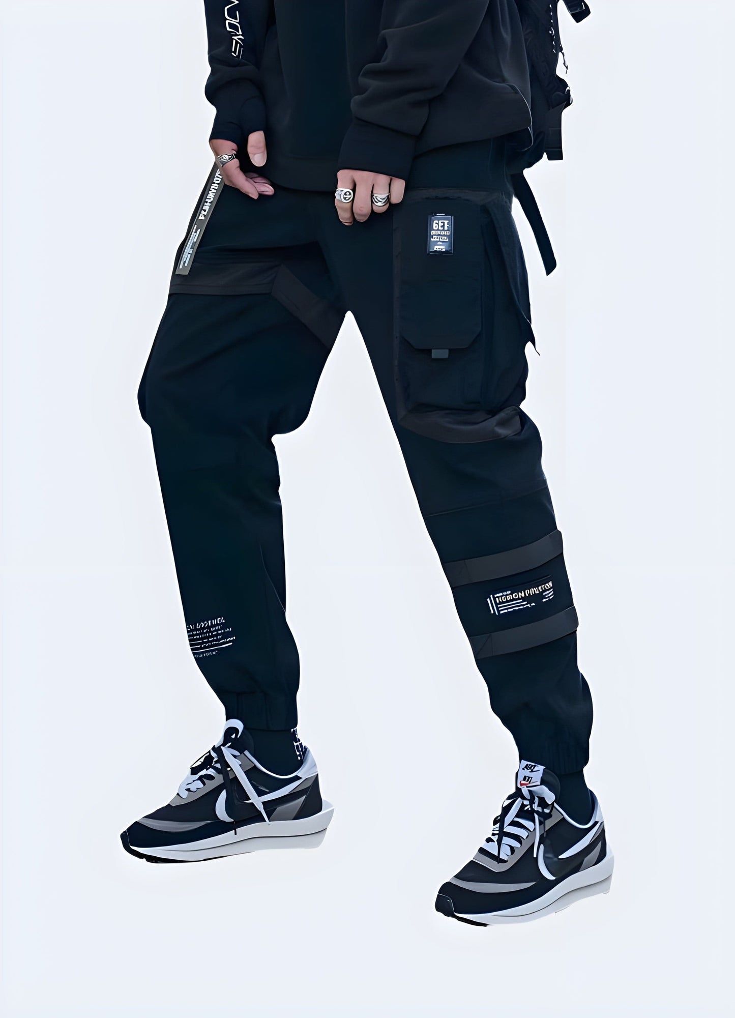 Front side view of a man wearing trendy baggy techwear pants, showcasing the garment's loose silhouette and modern aesthetics, perfect for fashion-forward tech enthusiasts in the UK.