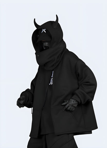 Side view of a man wearing an edgy black hoodie with horn accents, showcasing its distinctive design in the UK.