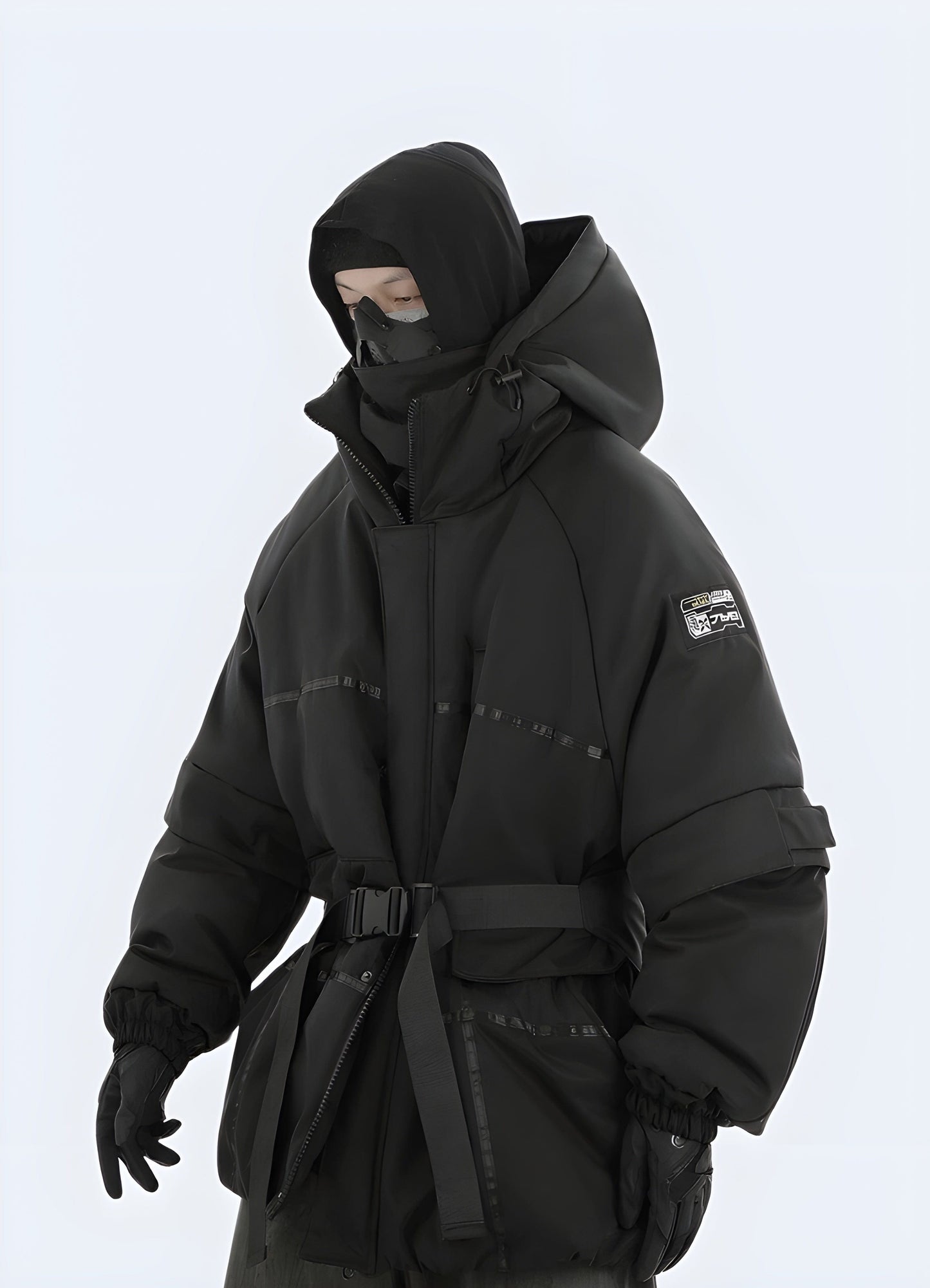 Front view of a model wearing a sleek black techwear jacket, showcasing its cutting-edge design and advanced features, perfect for UK's urban fashion scene.