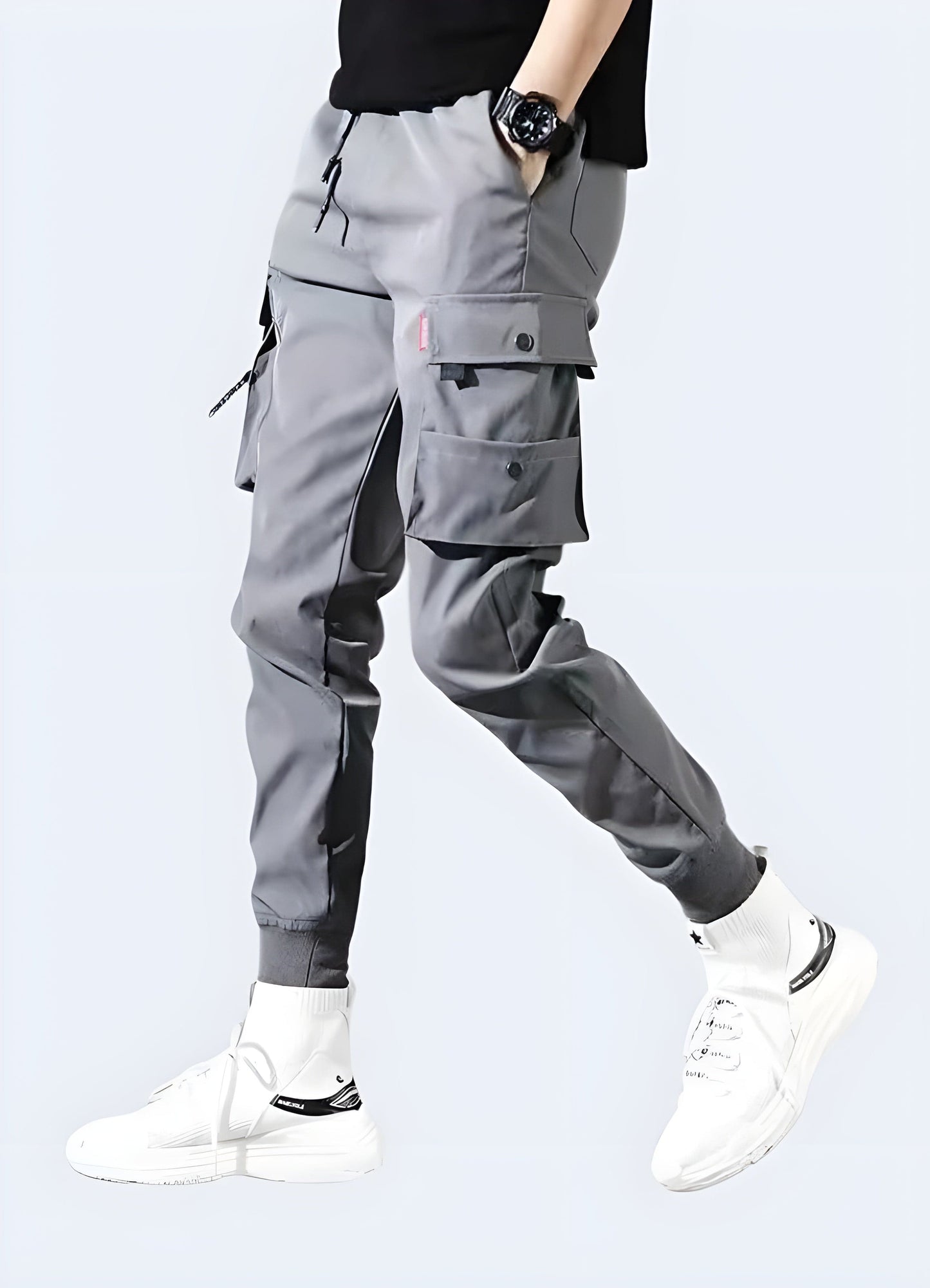 Front side view of a man sporting stylish grey slim-fit cargo pants, highlighting the slim profile and versatile color, ideal for UK consumers seeking a trendy and functional look.