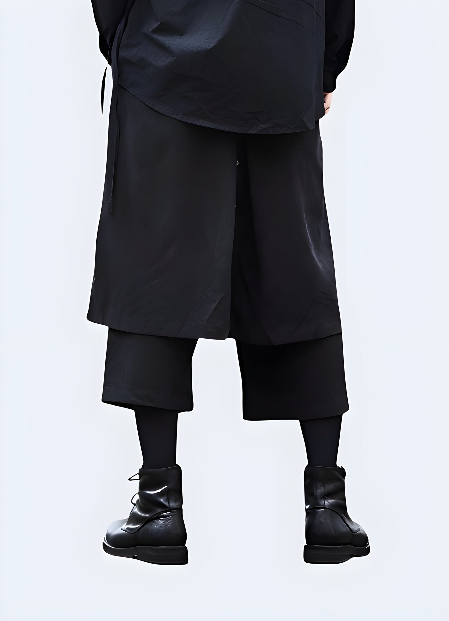  Back view of a man wearing fashionable hakama pants, showcasing the garment's distinctive silhouette and versatile design, perfect for making a statement in the UK streetwear scene.