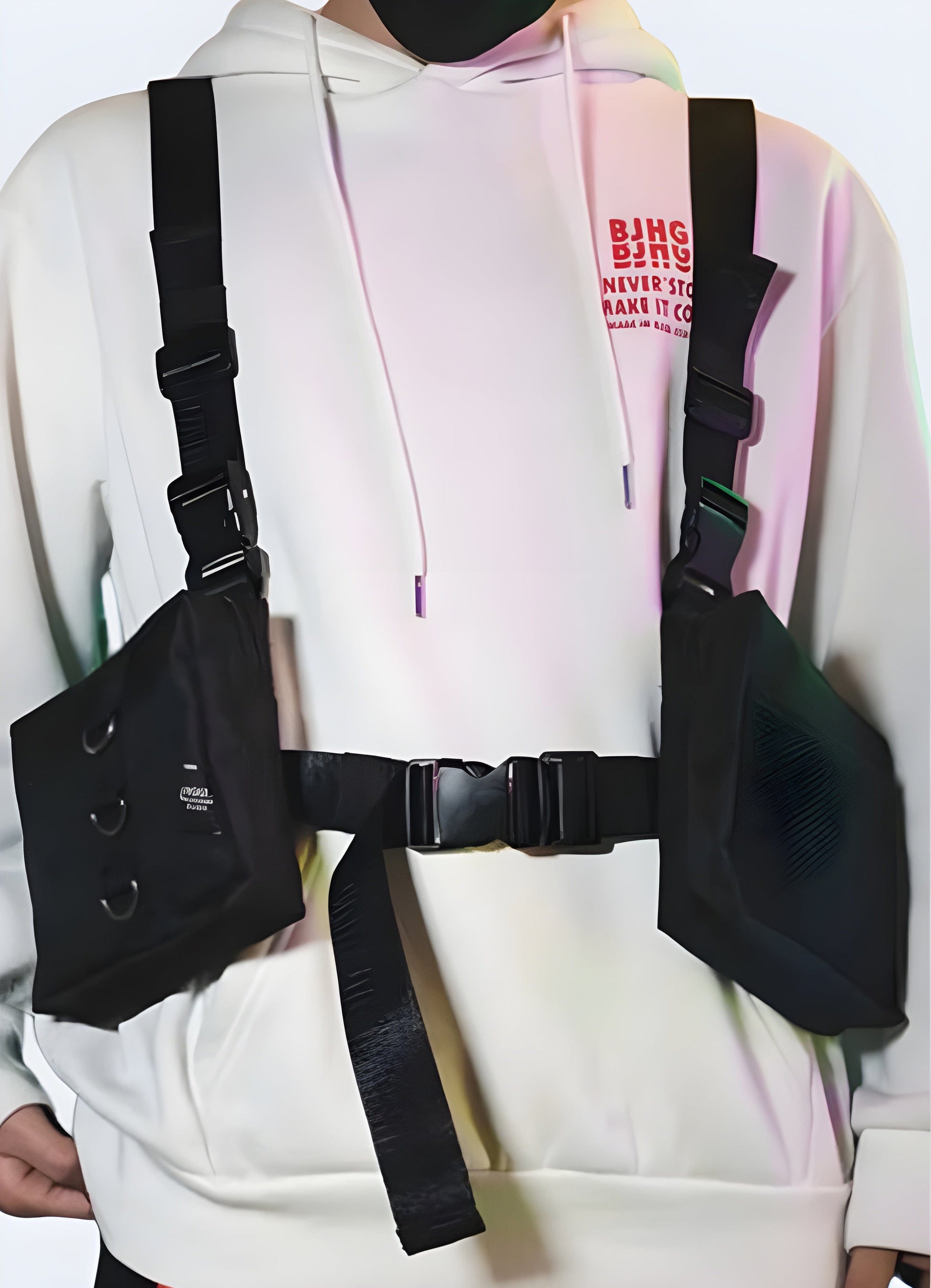 Front view of a man wearing a black multi-pocket harness chest pouch with a large fanny pack-style compartment on the chest, suitable for outdoor activities and travel.