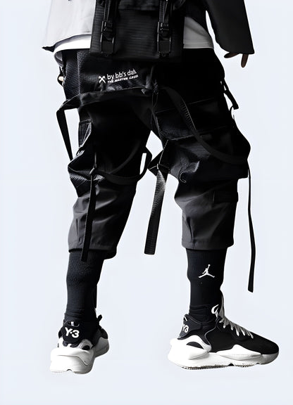 Rear view of a man modeling fashionable black streetwear pants, showcasing the garment's premium quality and attention to detail, ideal for the UK streetwear scene.