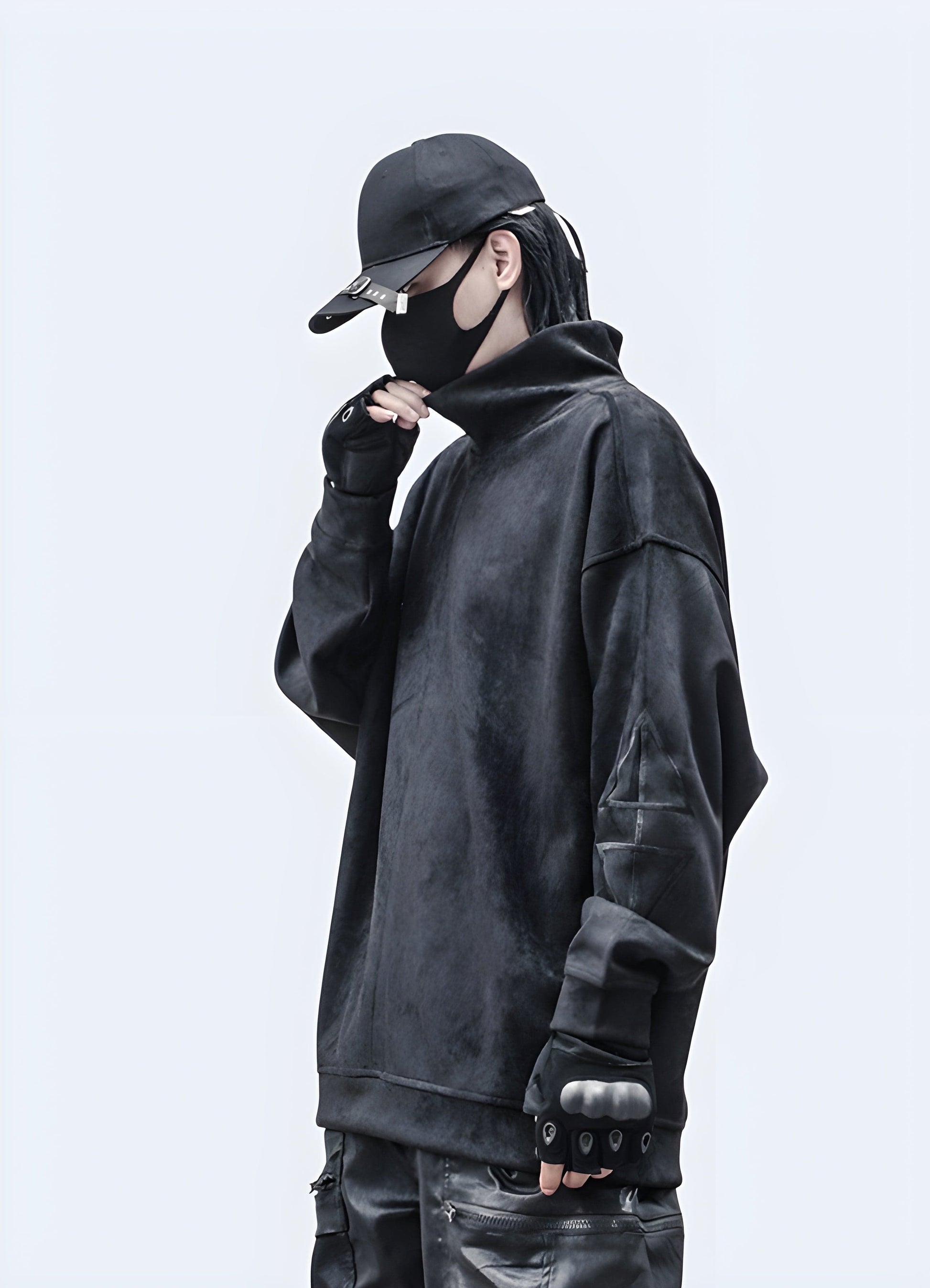 Side view of a man wearing a cutting-edge techwear pullover, showcasing its sleek silhouette in the UK.