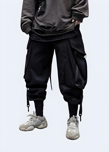  Side view of a man modeling stylish techwear samurai pants, highlighting the fusion of ancient Japanese aesthetics with contemporary techwear features, a must-have for adventurous fashion lovers in the UK.