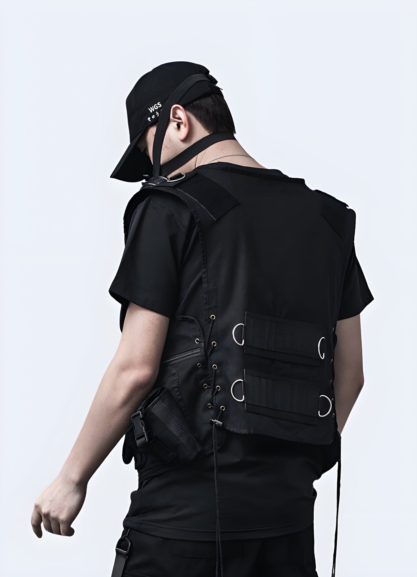 Right view of a man donning a techwear utility vest, emphasizing its ergonomic design and practical appeal, a must-have for UK techwear enthusiasts.