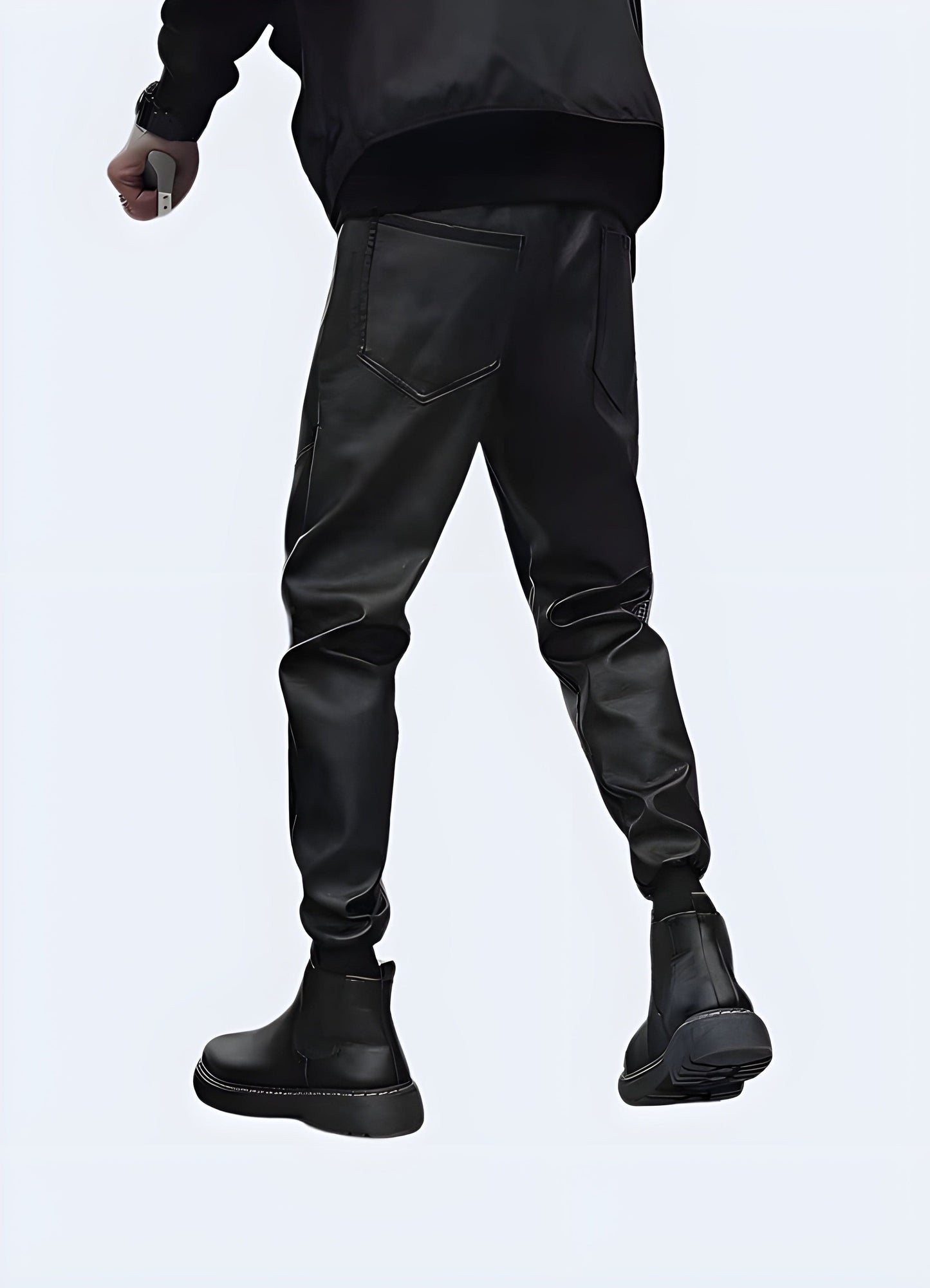 Back view of a man wearing durable techwear waterproof pants, showcasing the garment's sleek design and functional features, perfect for outdoor enthusiasts in the UK.