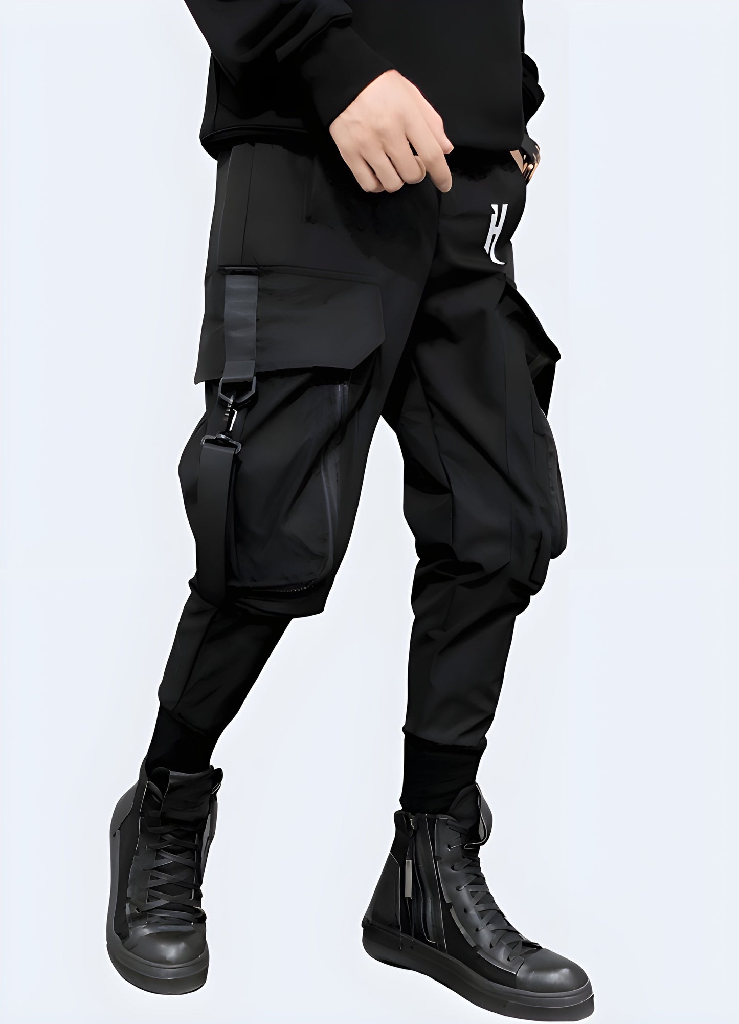 UK man modeling dark techwear cargo pants with functional pockets, right side view.