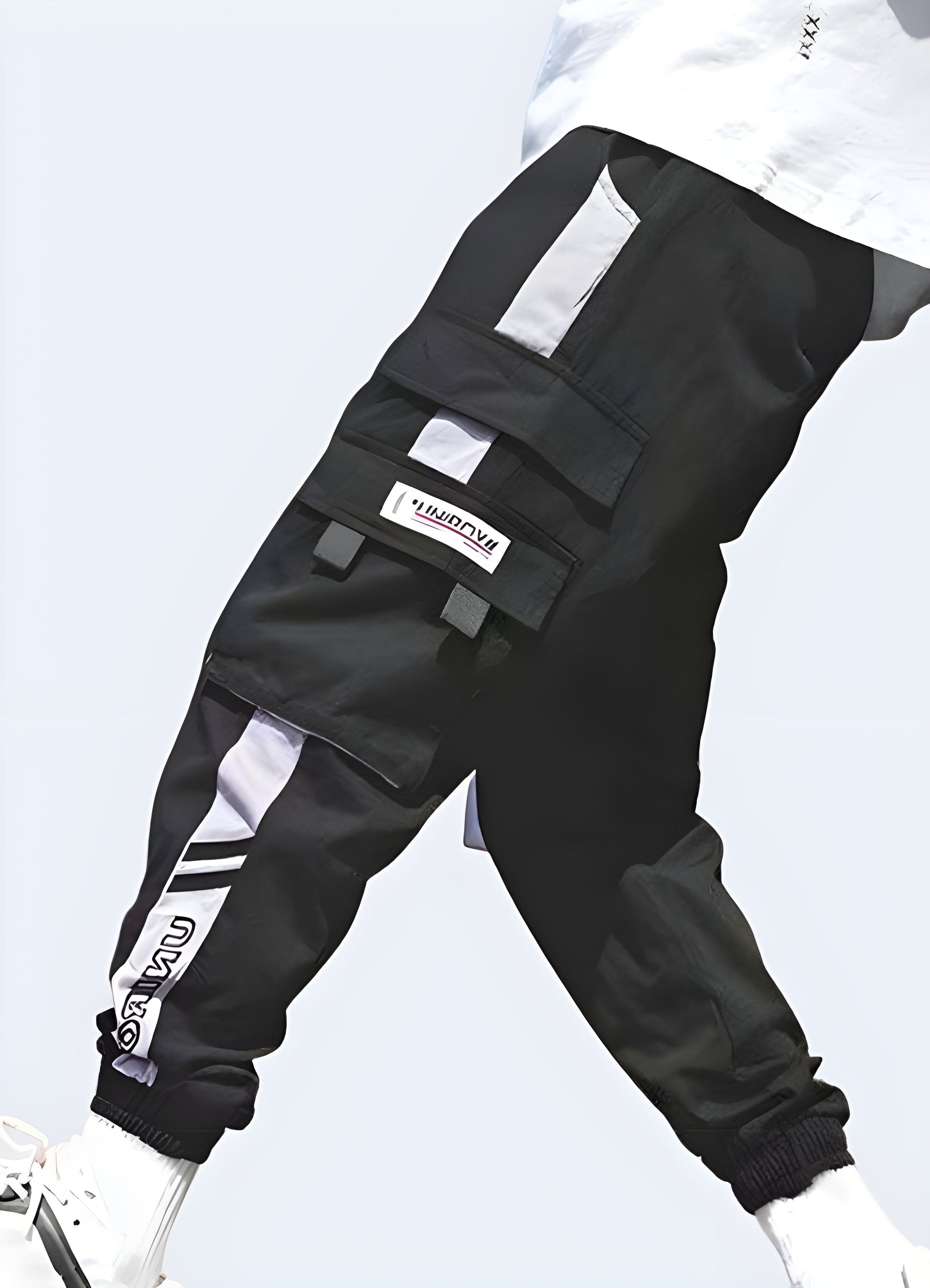 Side view of a man sporting cutting-edge purple techwear pants, highlighting the garment's ergonomic fit and high-performance materials, ideal for UK consumers seeking a distinctive and functional techwear look.