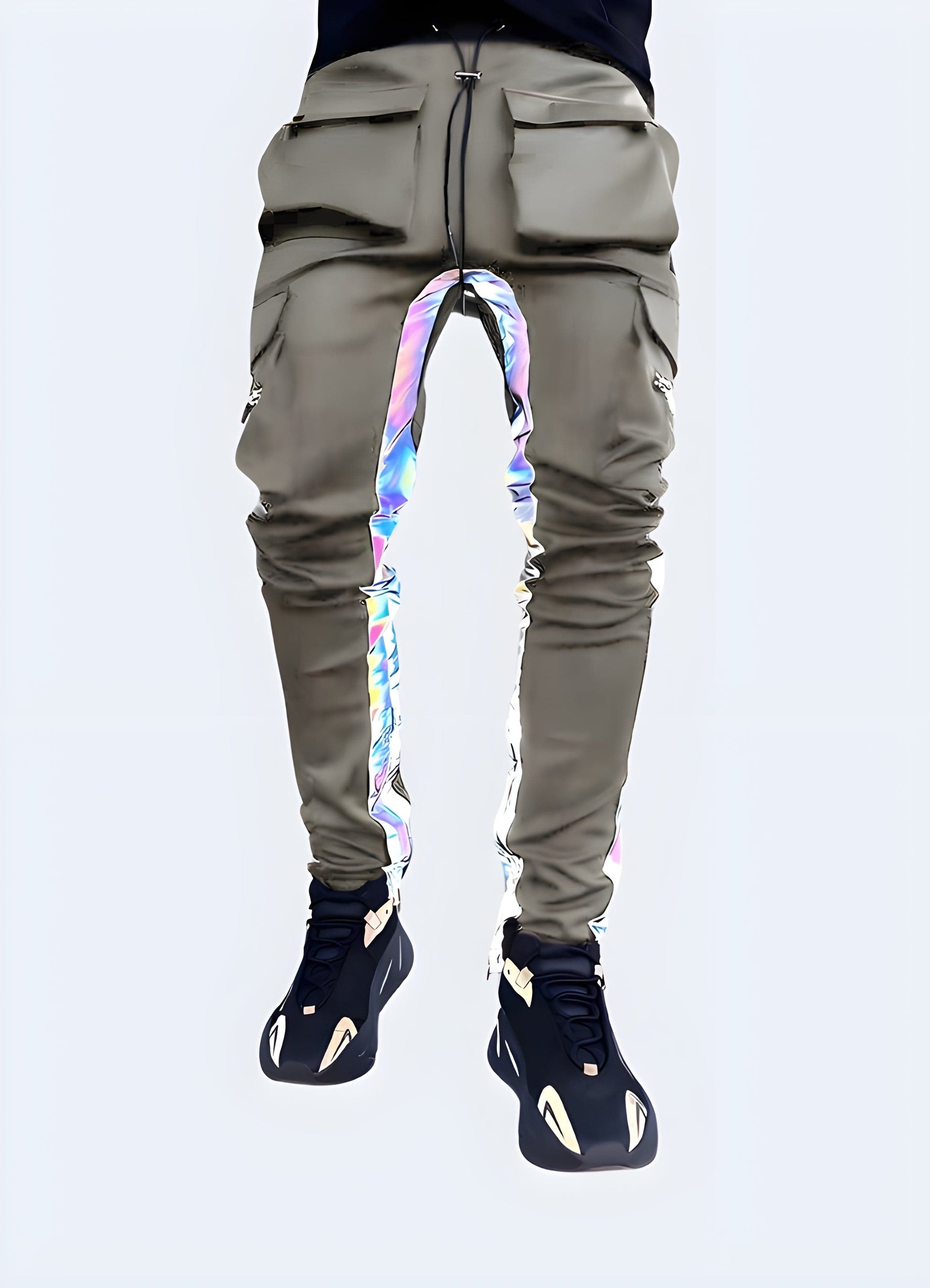 Front view of a model sporting black cargo pants with reflective detailing, numerous pockets, and a relaxed fit, ideal for streetwear and functional fashion.