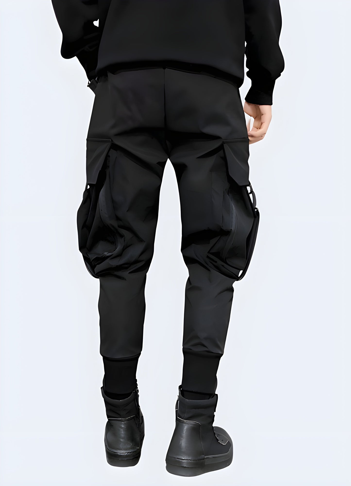 Rear view of man in dark techwear cargo pants with adjustable straps, UK fashion.