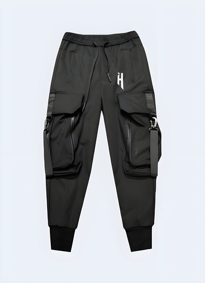 Black techwear cargo trousers with multiple utility pockets and straps, front view, UK style.